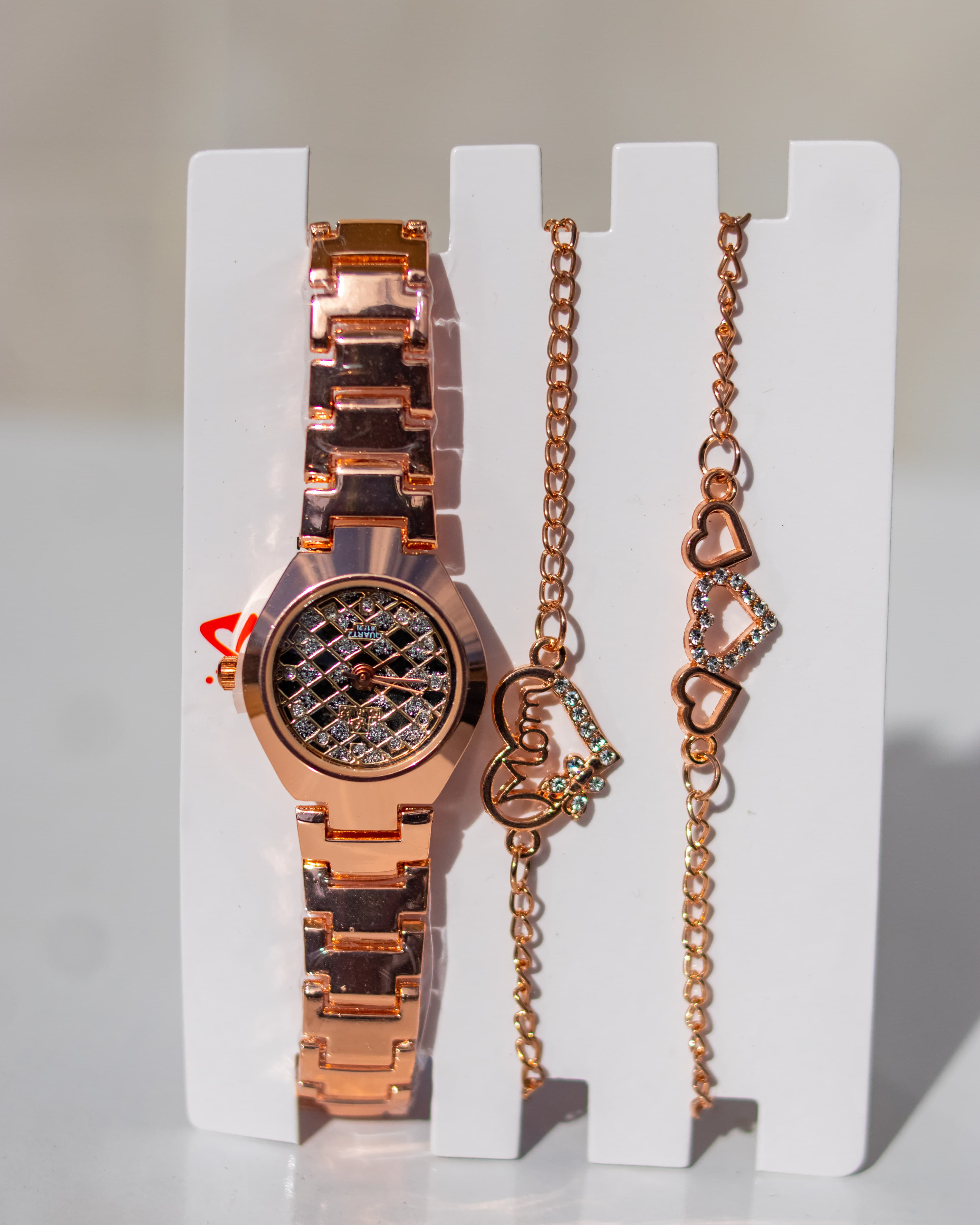 Luxurious crystal-gold tone wristwatch paired with matching bracelets