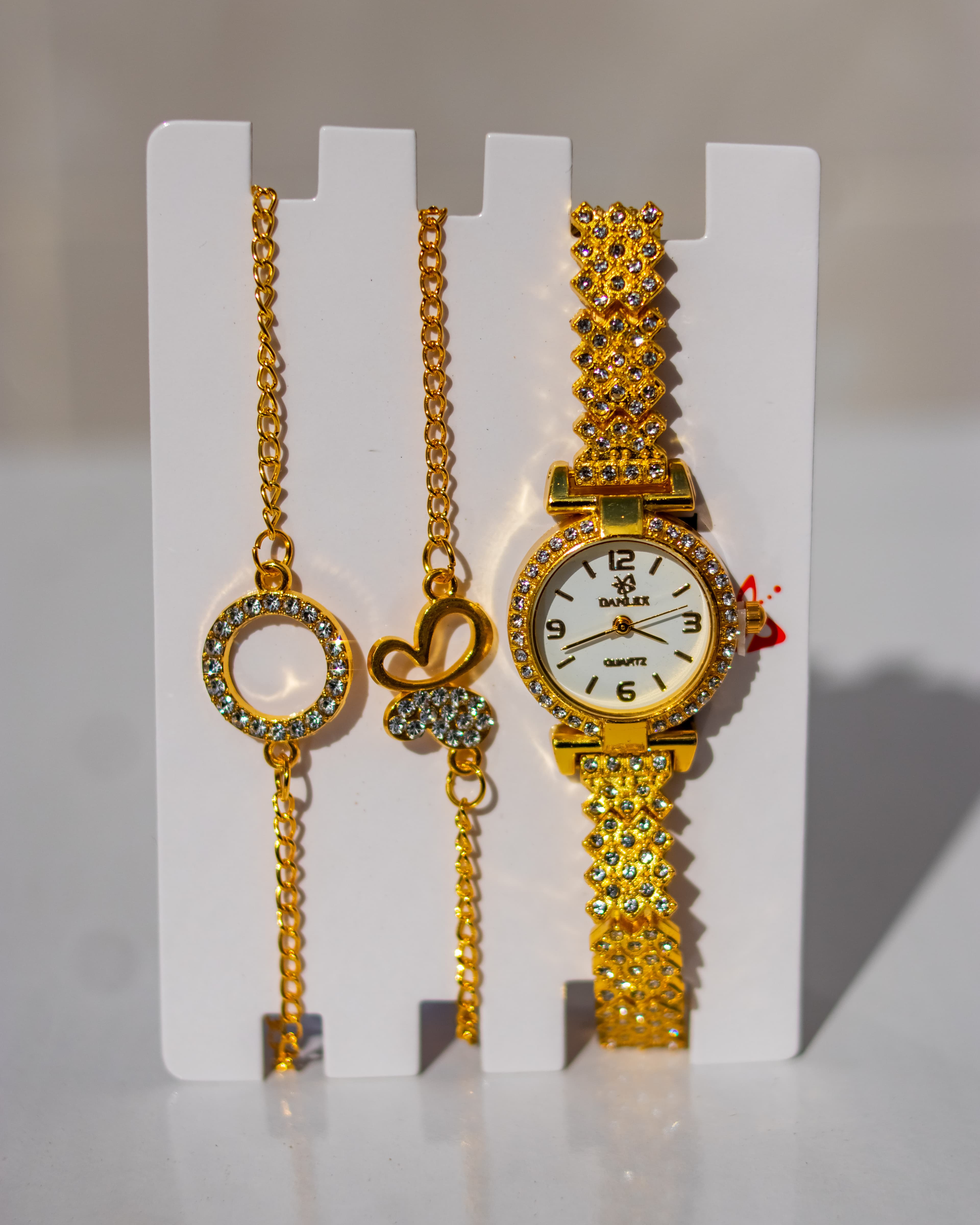 Luxurious gold tone wristwatch paired with matching bracelets