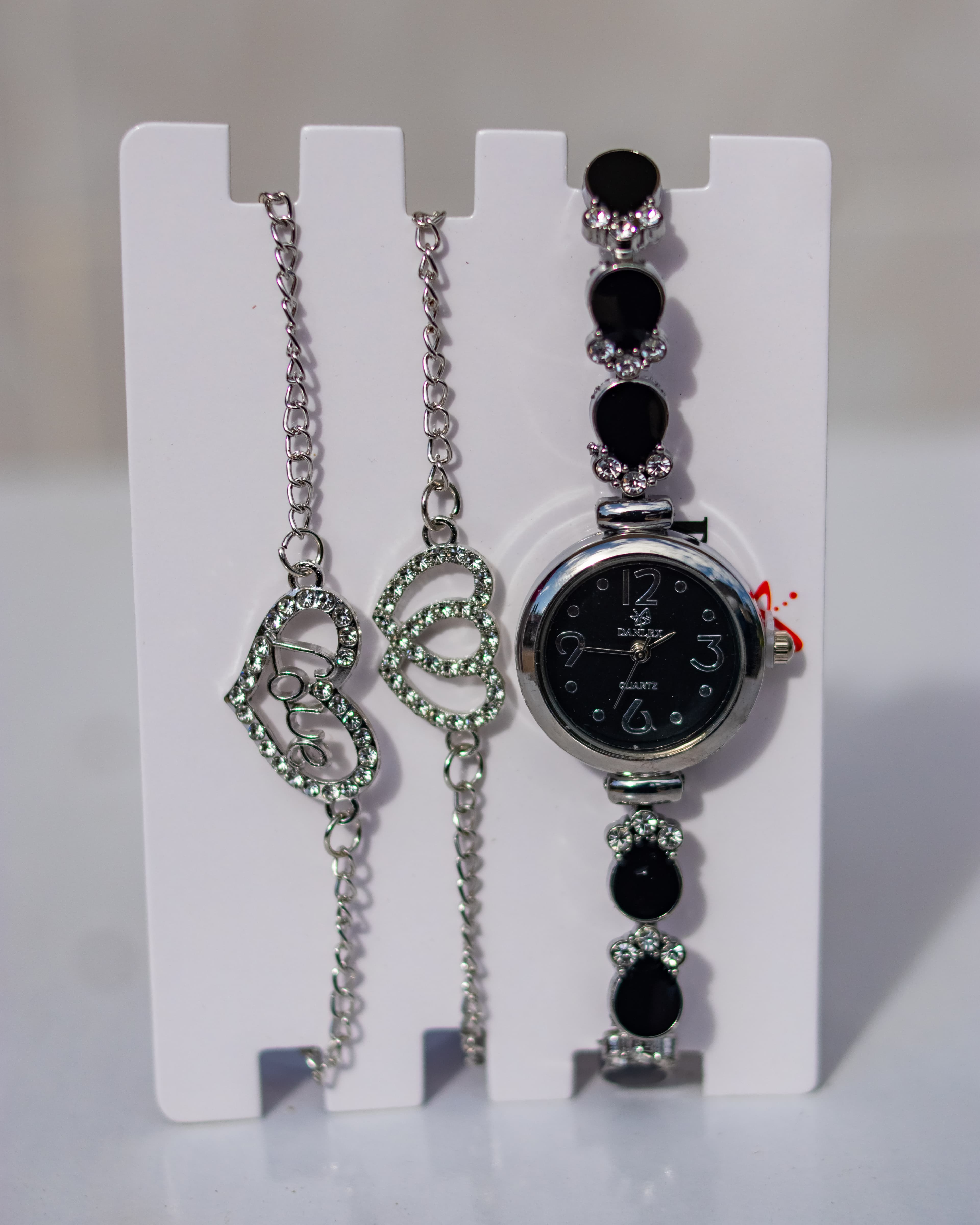 Elegant silver wrist watch paired with matching bracelets
