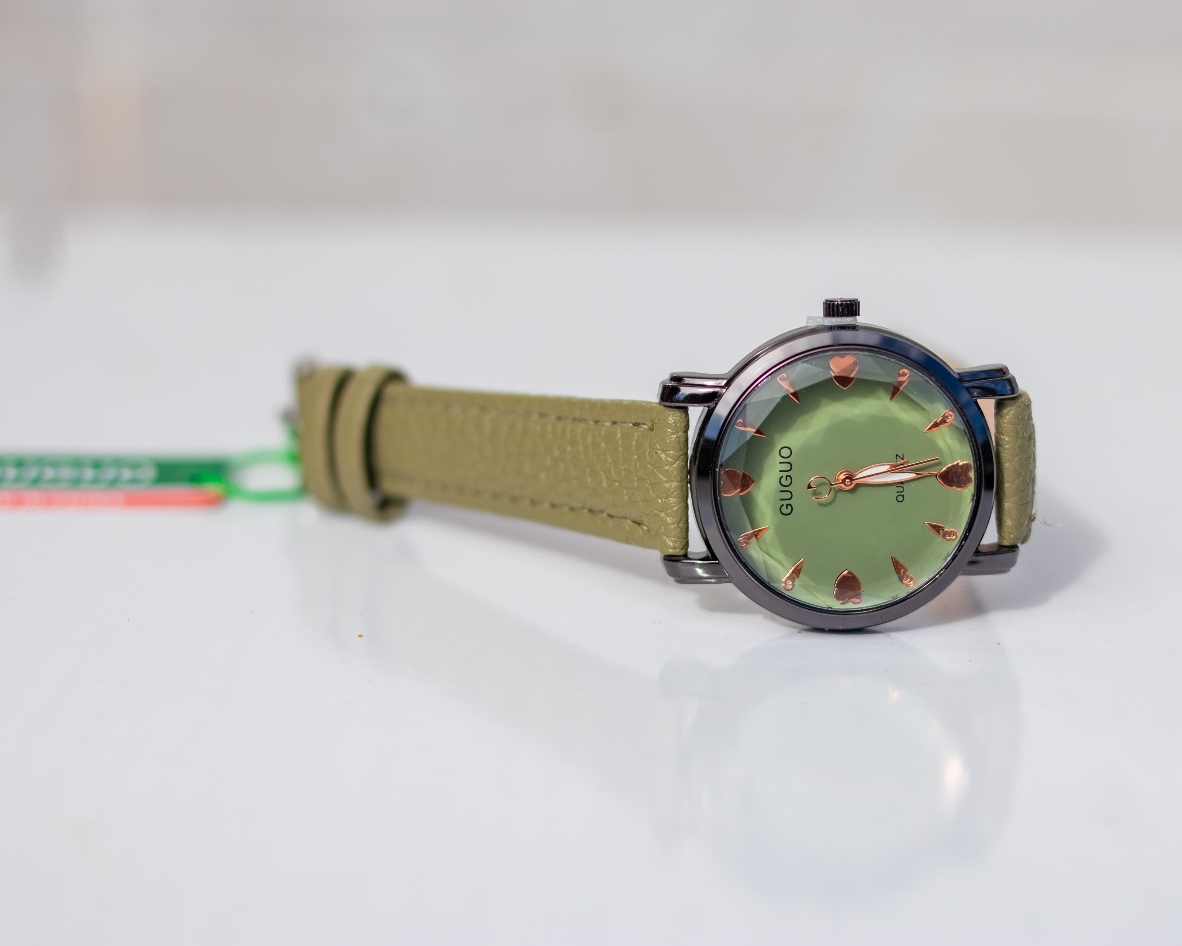 Crystal studded dial wristwatch with a beige leather strap